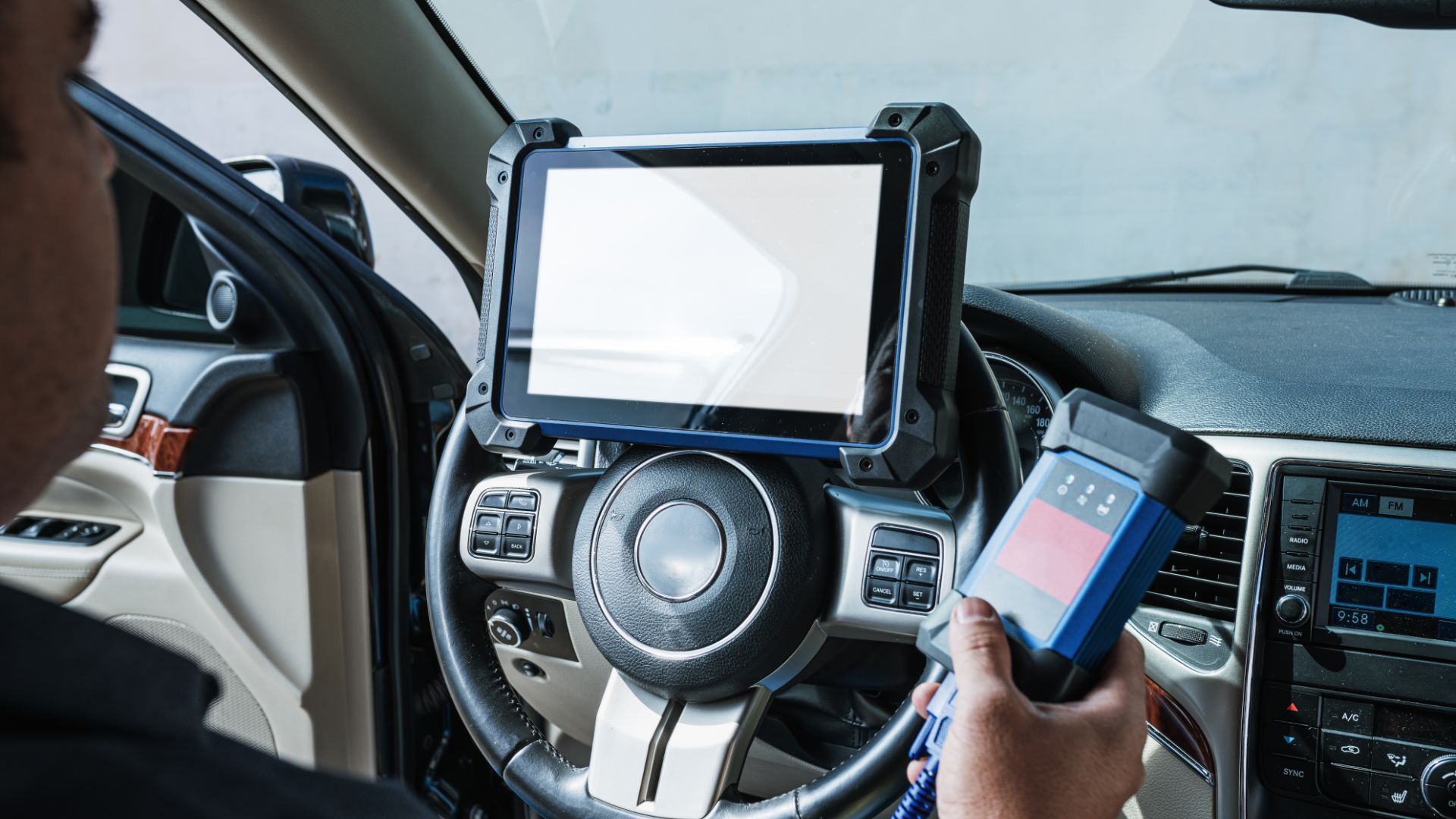 a man holding a cell phone while driving a car.