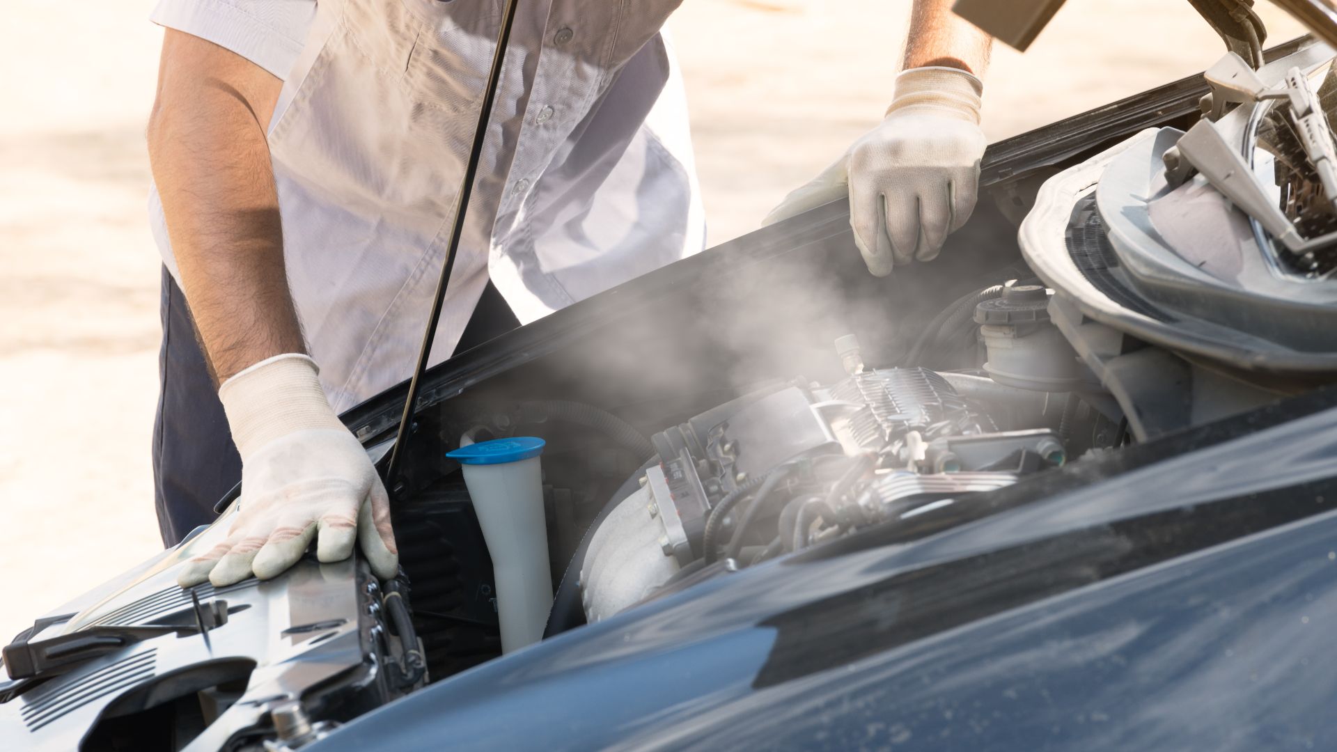 a man in white gloves working on a car engine.