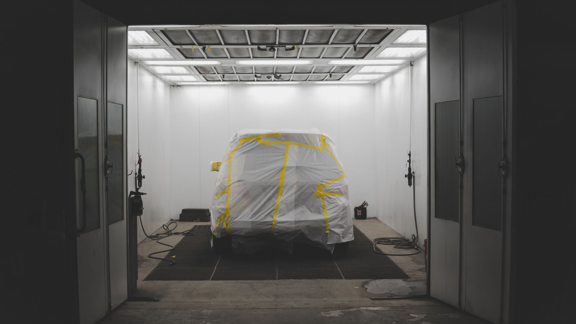 a car covered in a sheet in a garage.