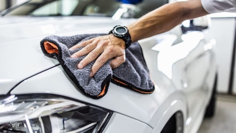 a man cleaning a car with a micro micro micro micro micro micro micro micro micro.