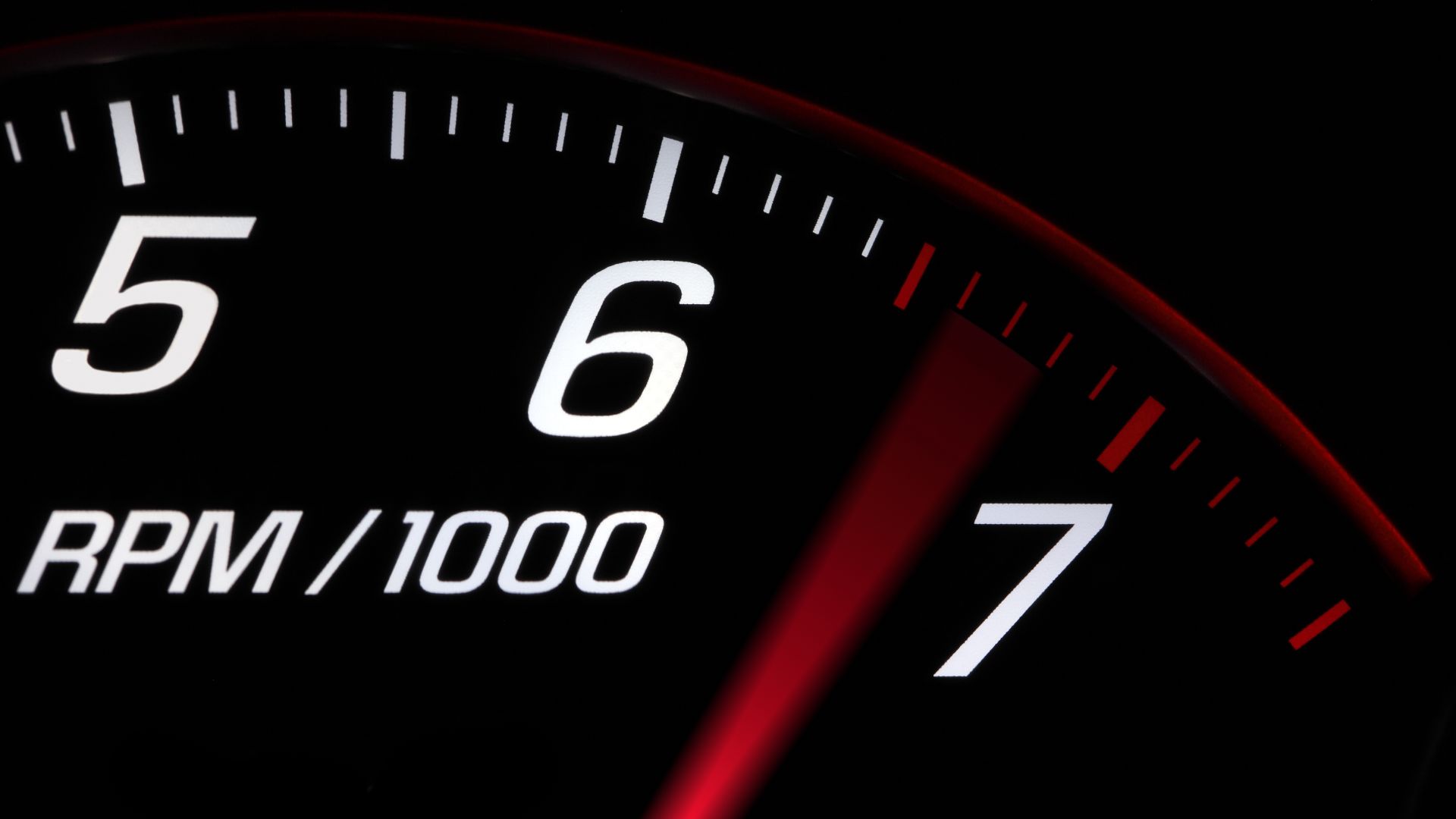 a close up of a speedometer in the dark.