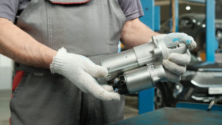 a man working on a machine in a garage.