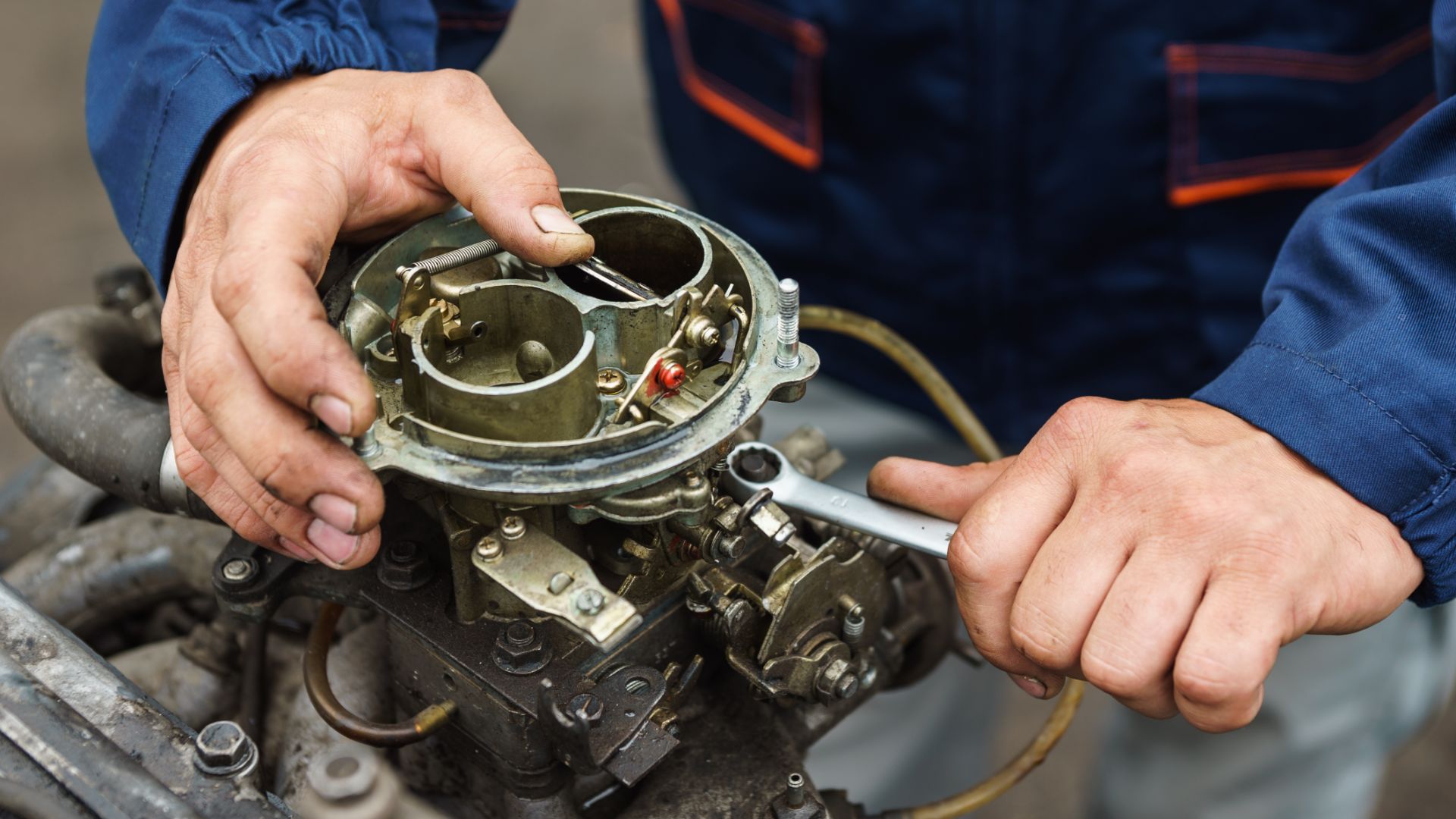 a close up of a person working on an engine.