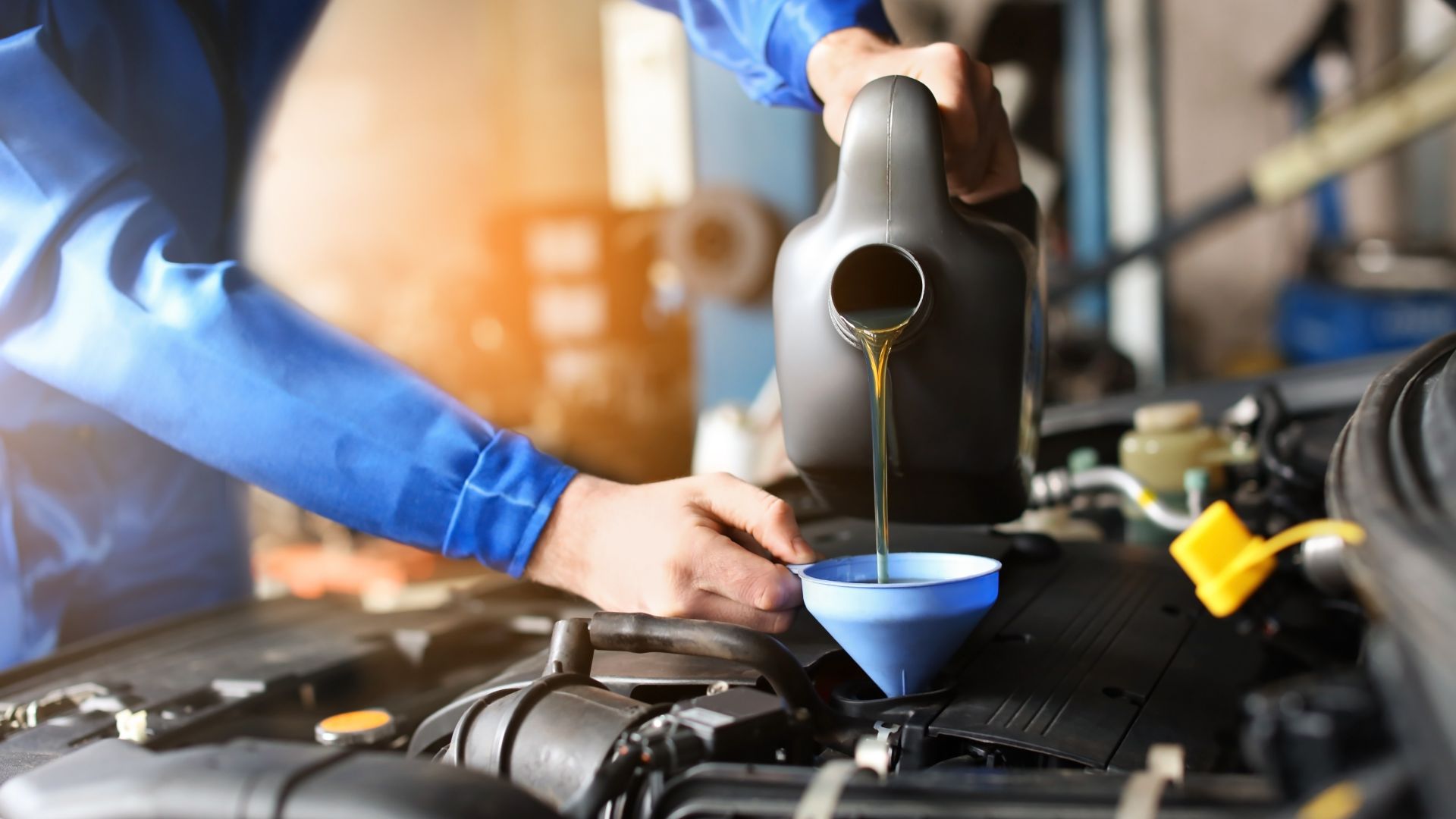 a man pouring oil into a blue bowl.