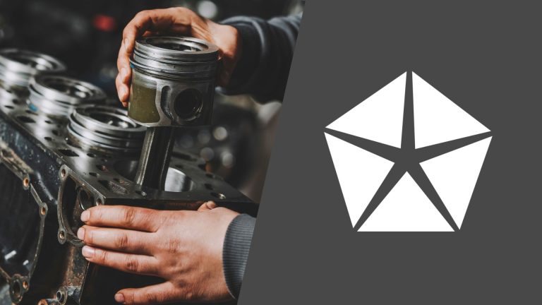 A man is working on a car engine with a logo on it.