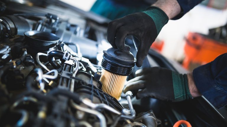 a man is working on a car engine.