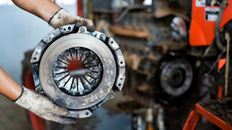 a close up of a person holding a piece of machinery.