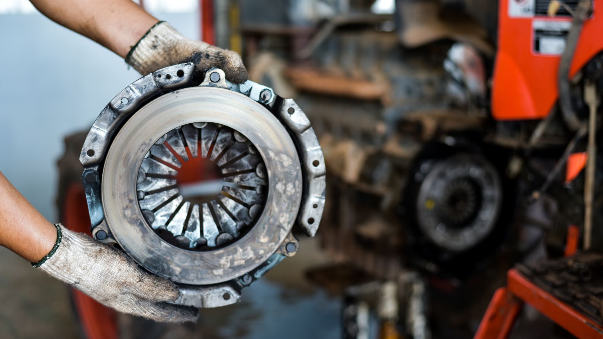 a close up of a person holding a piece of machinery.