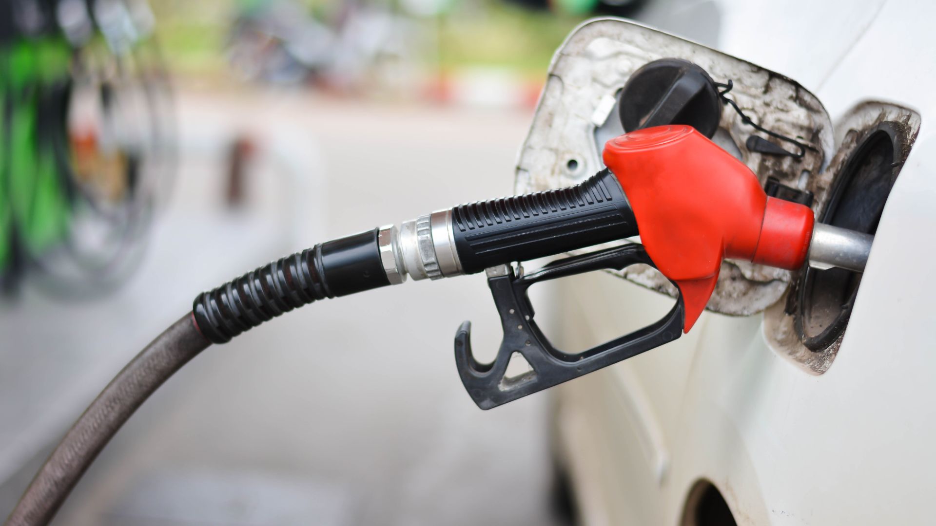 a white car with a red gas pump.