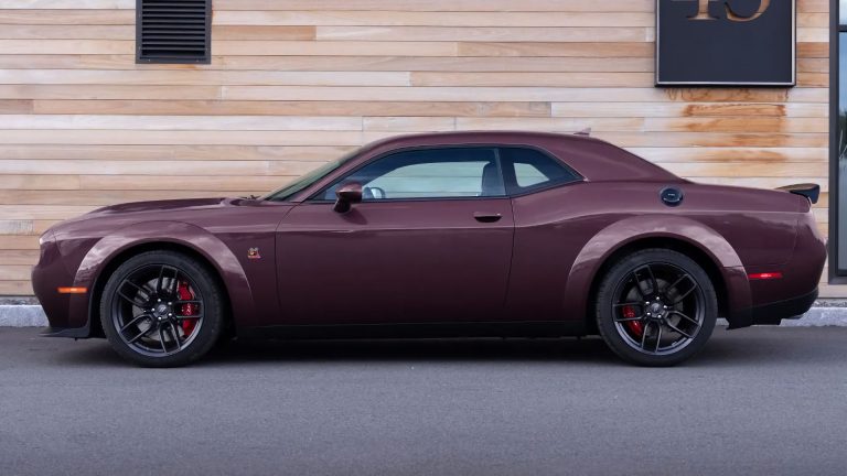 a purple sports car parked in front of a building.