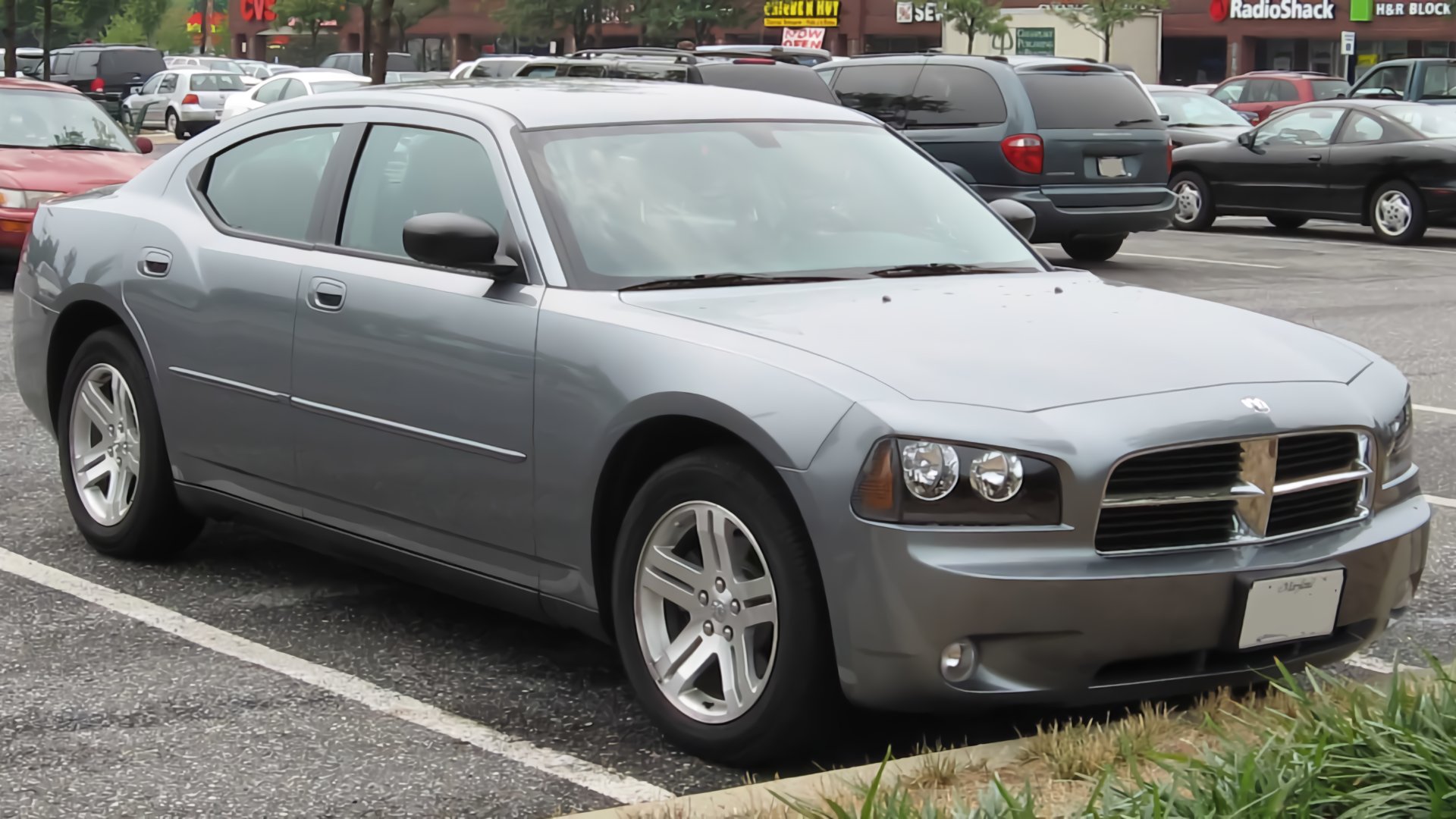 a silver car is parked in a parking lot.