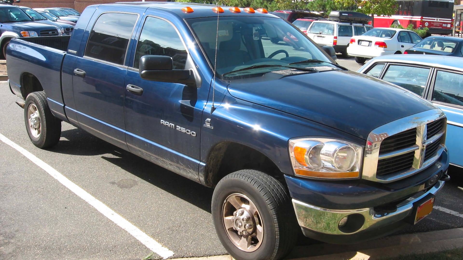 a blue pickup truck parked in a parking lot.