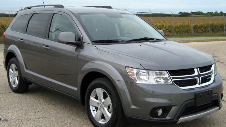 a gray dodge suv parked in a parking lot.