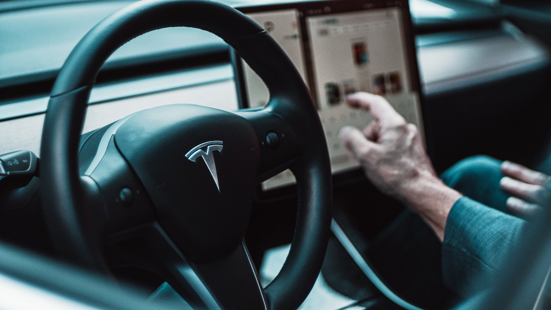 a person using a tablet in a car.