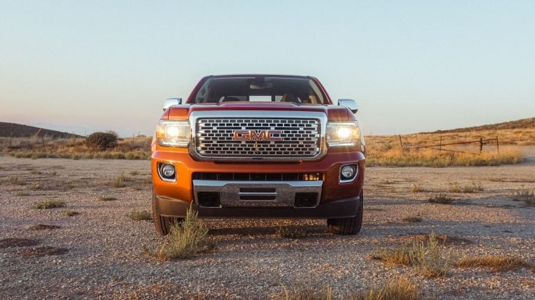 a red truck parked in the middle of a desert.