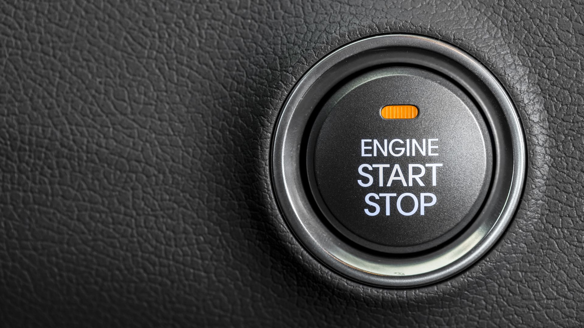 an engine start button on a car.
