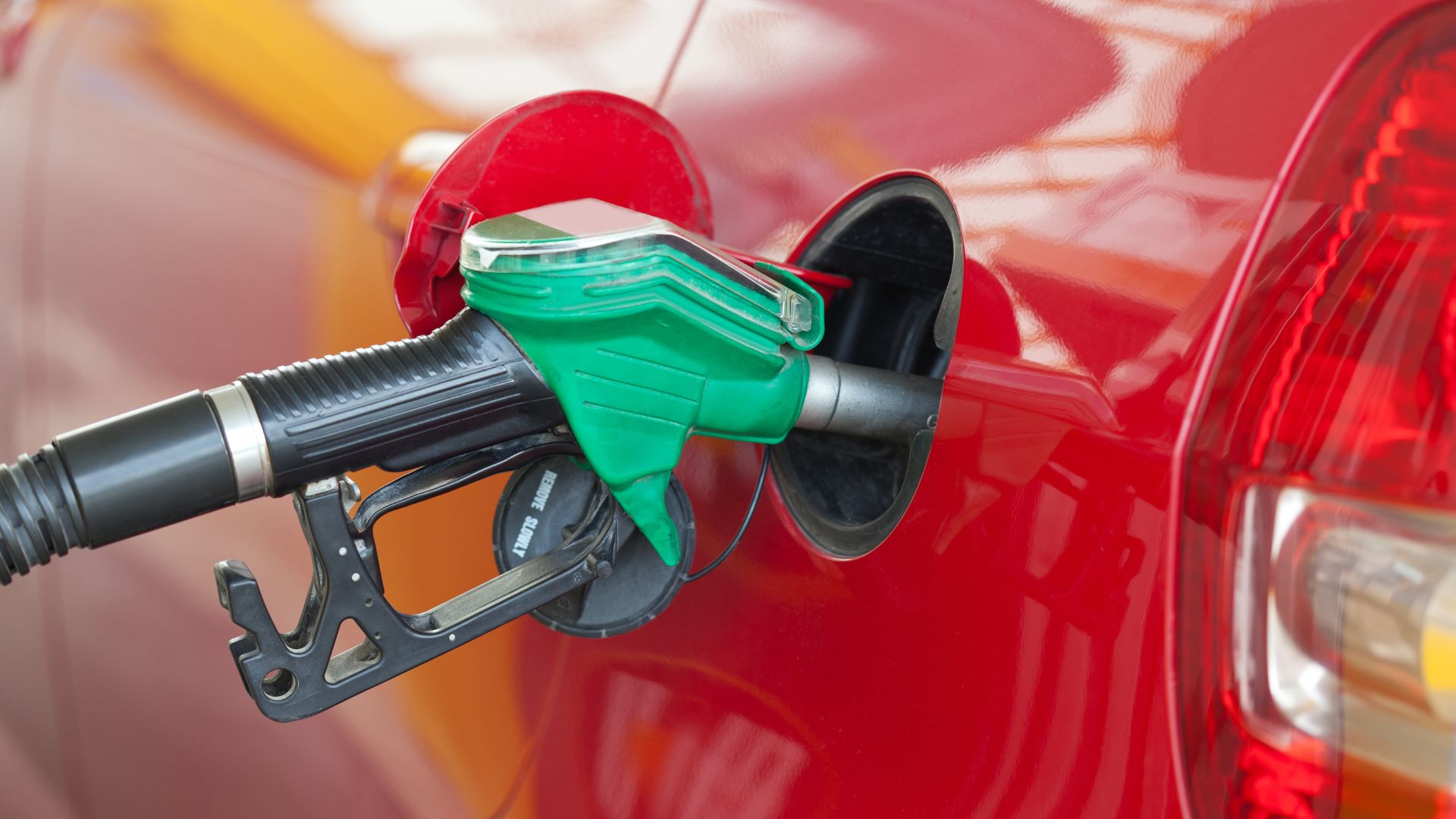 a red car with a gas pump attached to it.