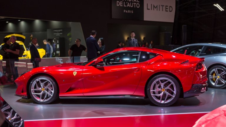 a red sports car on display at a car show.