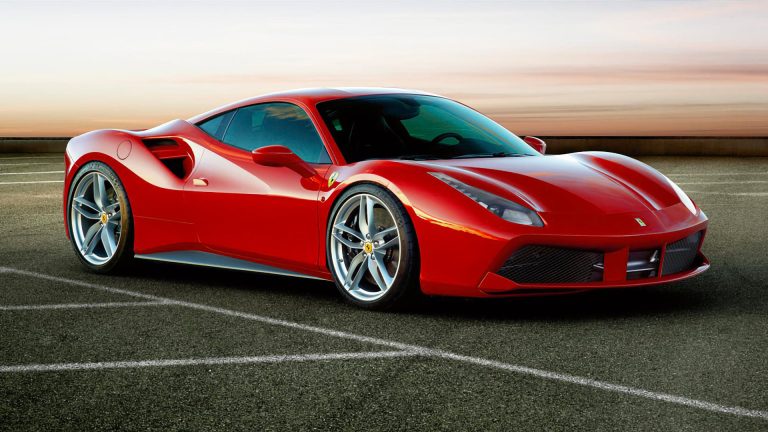 a red sports car parked in a parking lot.