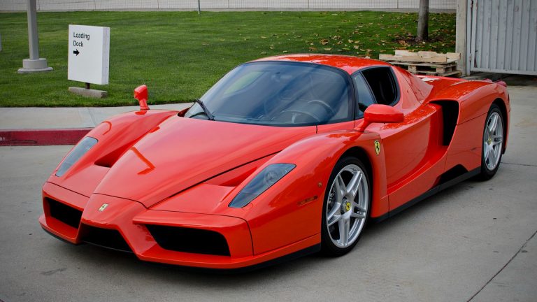 a red sports car parked in a parking lot.