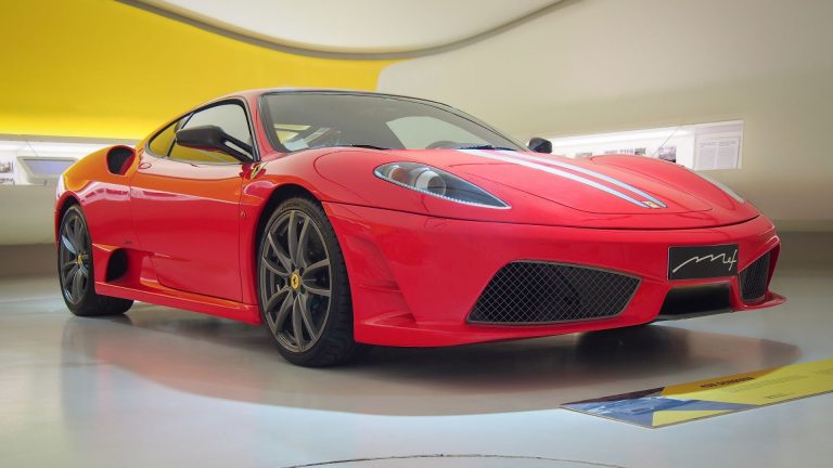 a red sports car parked inside of a building.