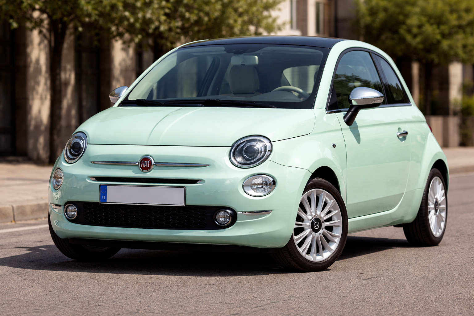 A light green Fiat 500 hatchback is parked on a street with trees and buildings in the background. Always check for Fiat 500 years to avoid when considering this stylish city car.