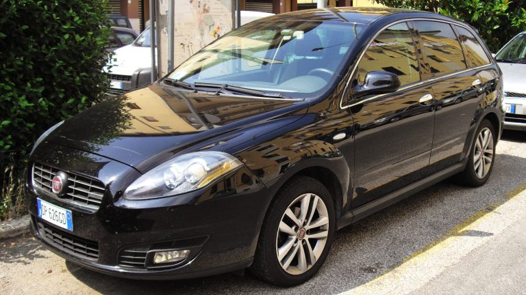 a black car parked on the side of the road.