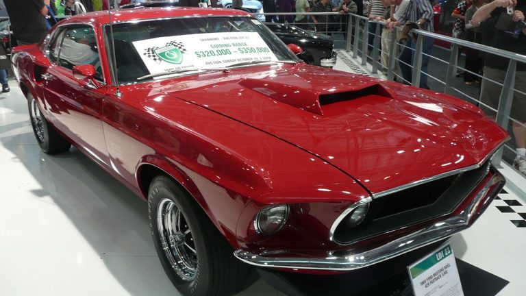 a red car on display at a car show.