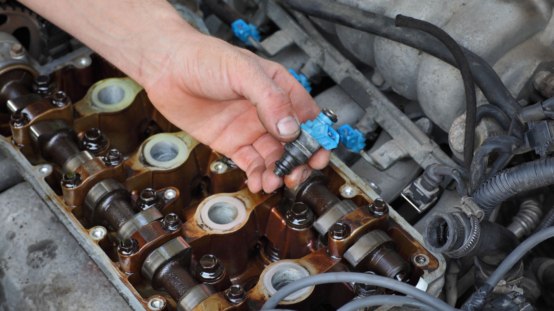 a person is working on a car engine.