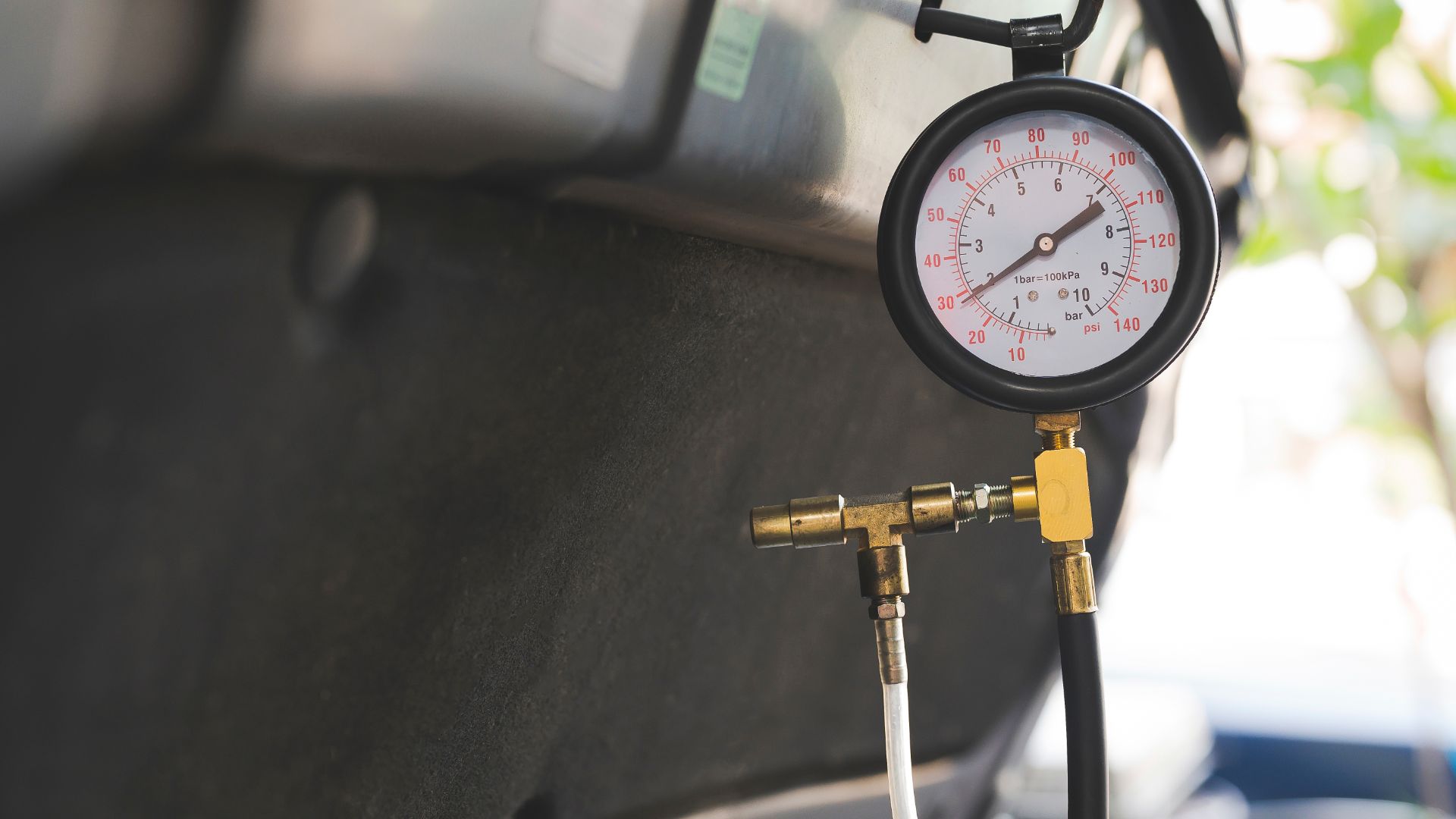 a pressure gauge attached to the side of a car.