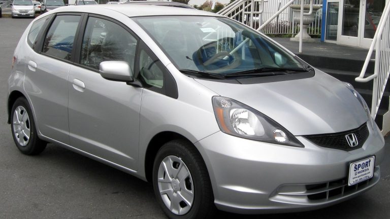 a silver car parked on the side of the road.