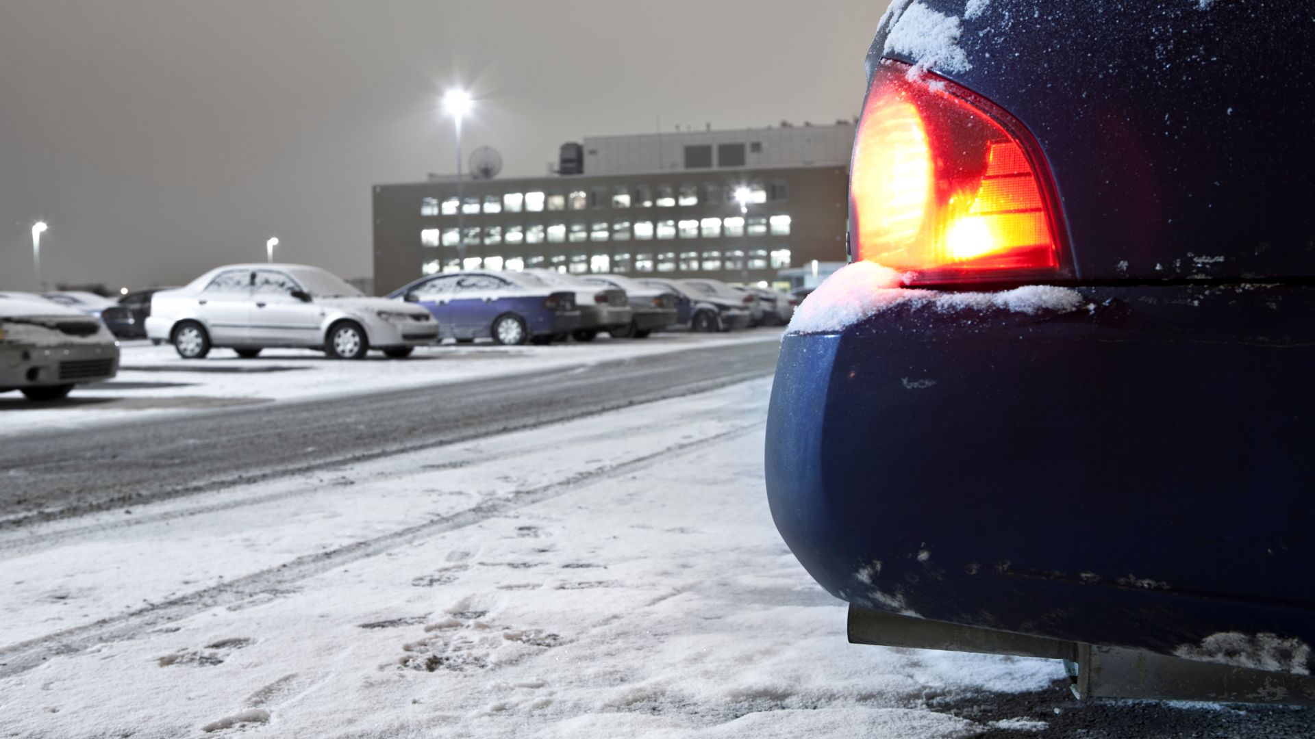 a car is parked on a snowy street.