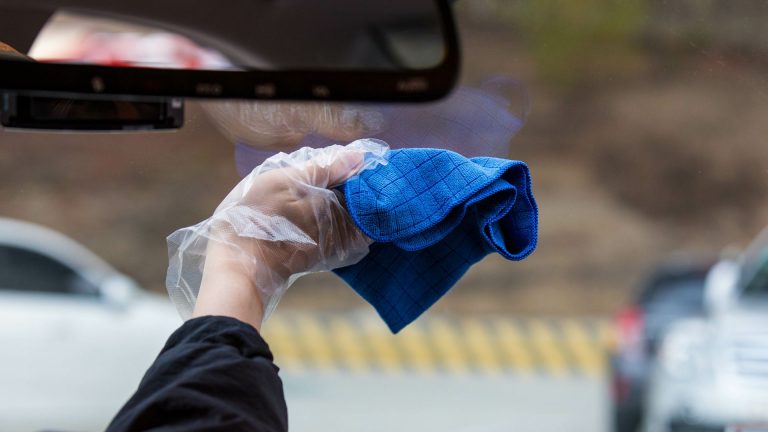 a person holding a blue cloth in their hand.