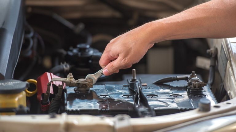 a man is working on a car's engine.