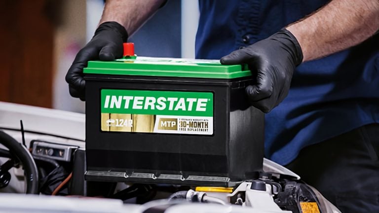 a man is working on a car battery.