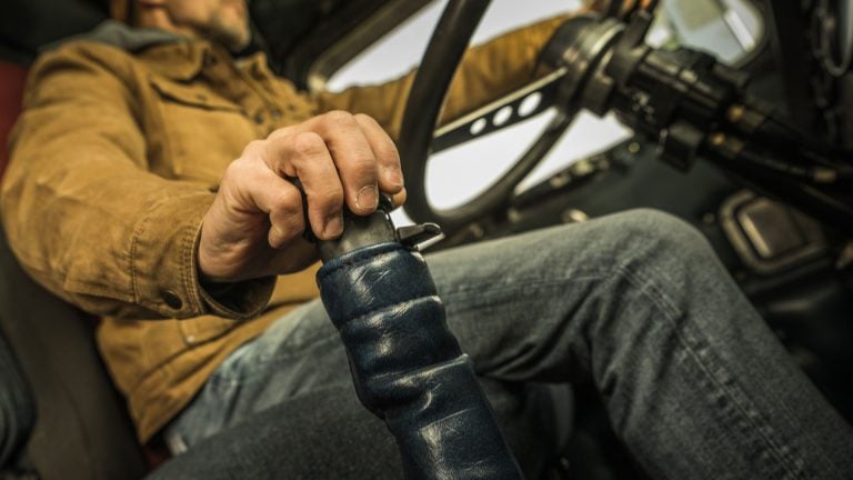 a man driving a tractor with a steering wheel.