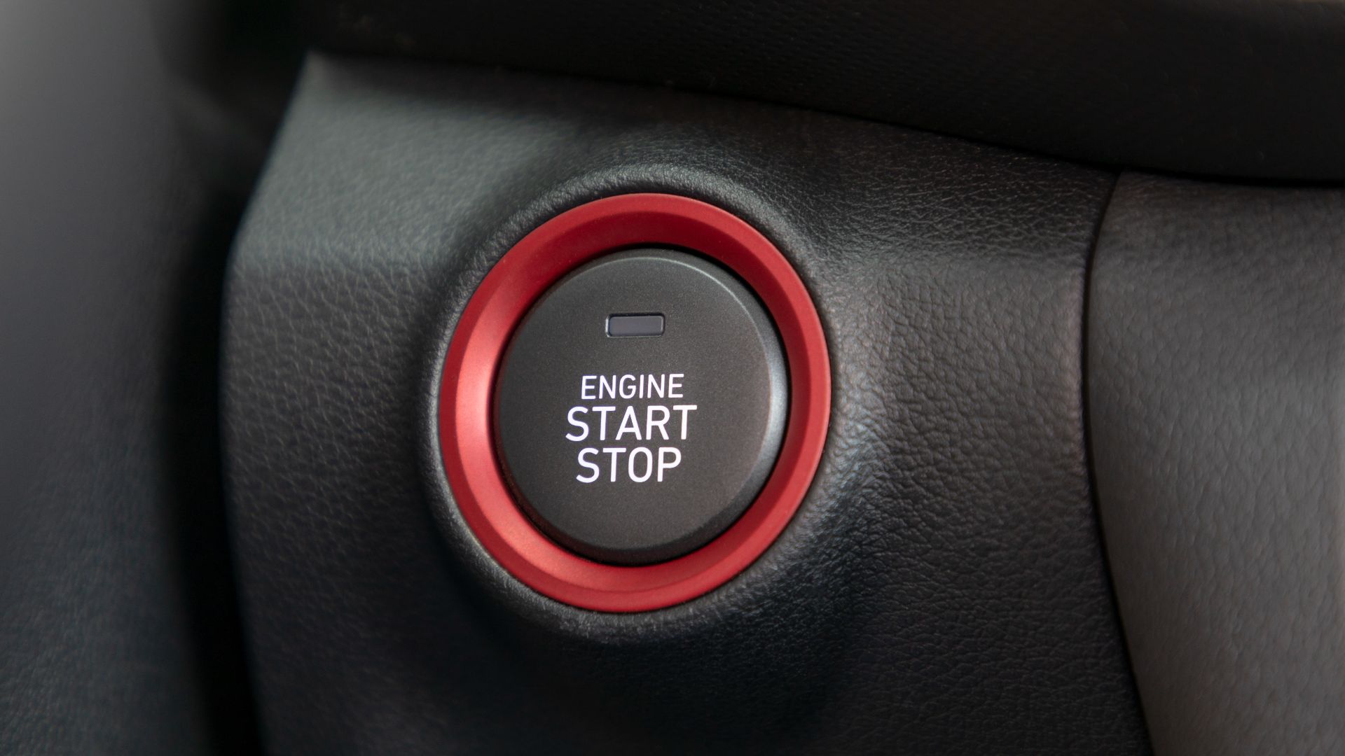 a close up of a button on a car's steering wheel.