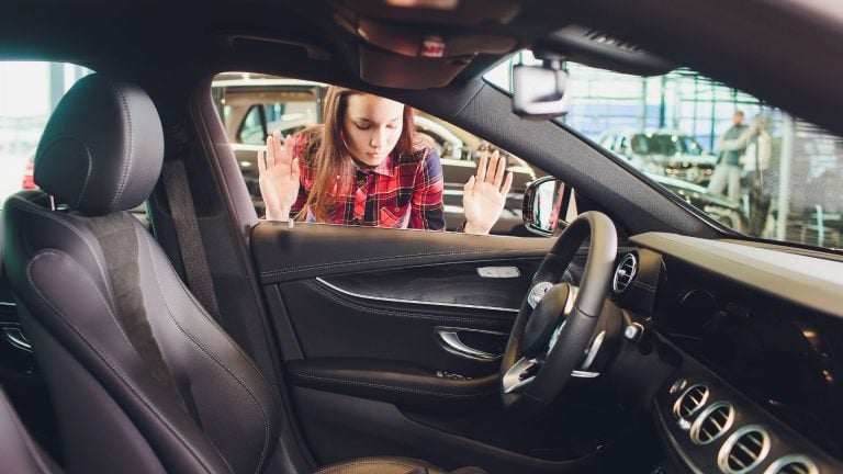 a woman sitting in the driver's seat of a car.