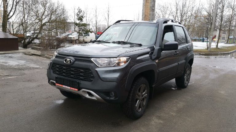 a black suv parked in a parking lot.