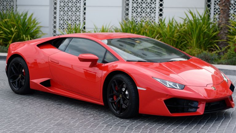 a red sports car parked in front of a building.