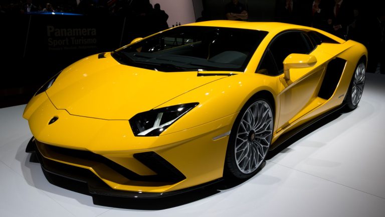 a yellow sports car is on display at a show.