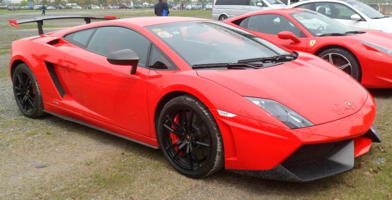 a red sports car parked in a parking lot.