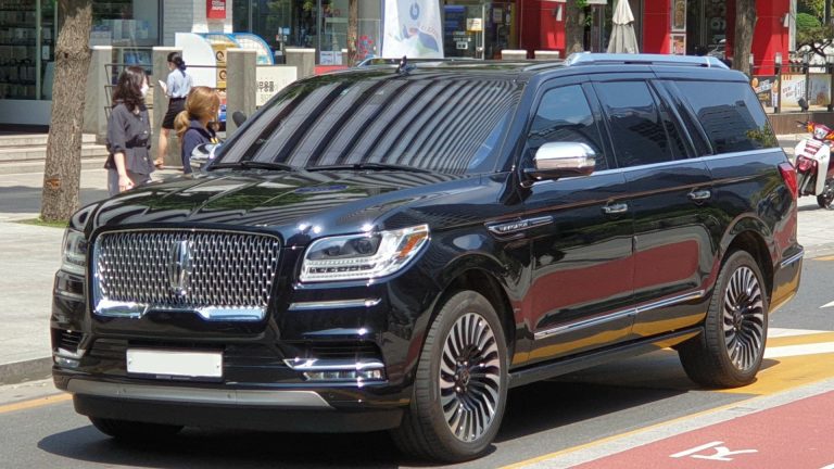 a black suv parked on the side of the road.