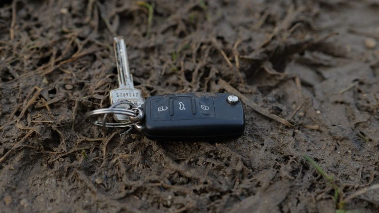 a car key is laying on the ground.