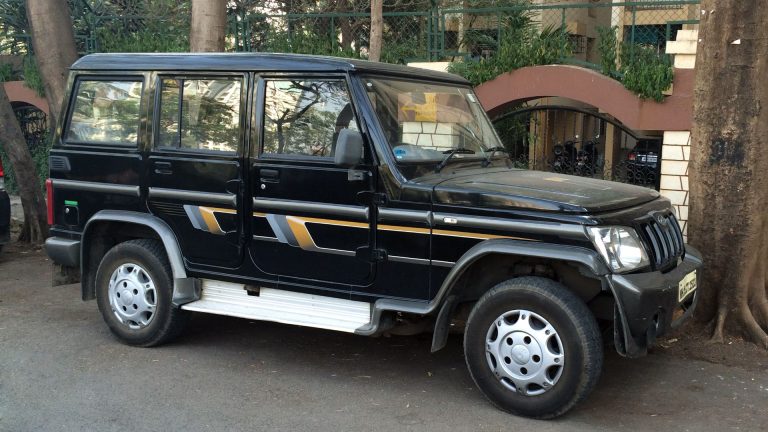 a black suv parked in front of a building.