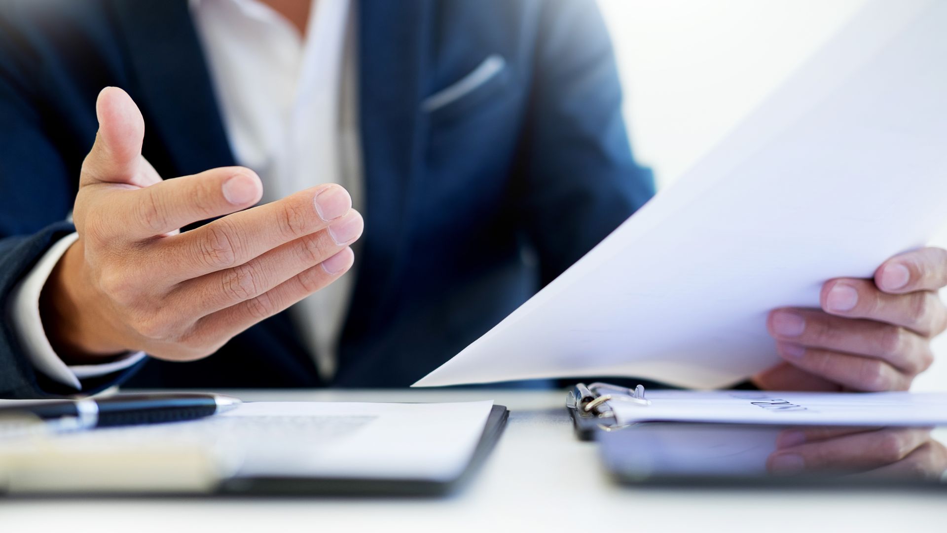 a man in a suit holding a piece of paper.