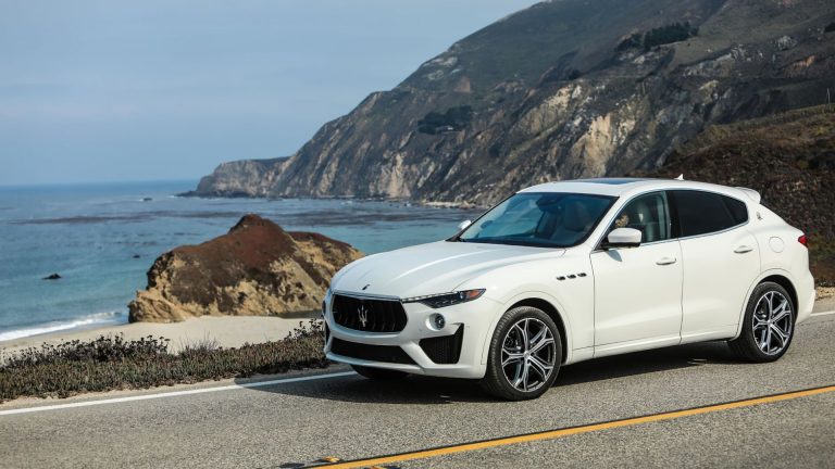 a white masera parked on the side of the road.