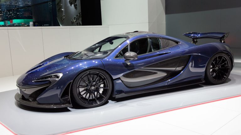 a blue sports car on display at a show.