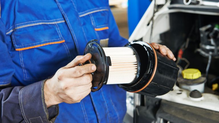 mechanic holding a fuel filter