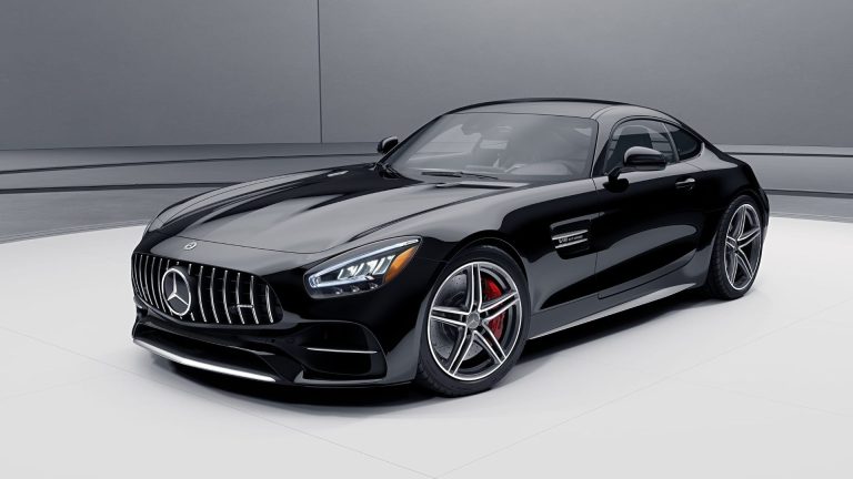 a black mercedes sports car parked in a garage.